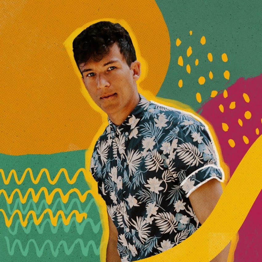 A man in a hawaiian shirt standing in front of a vibrant background.