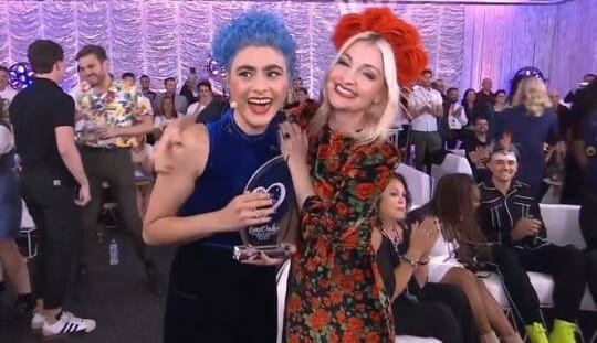 Two women with blue hair posing for a picture. Stunning, fashionable.
